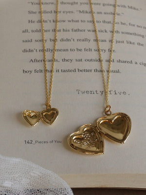 Heart locket and heart jewelry in gold color with 18k gold plating with the background of novel page